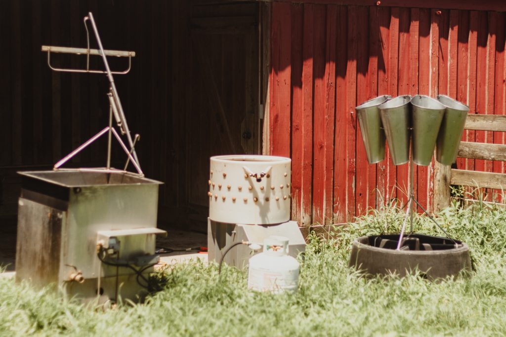 Chicken processing equipment including cones, scalding tank and plucking machine