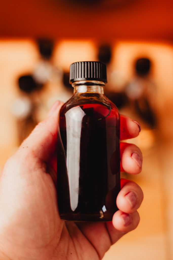 Bottle of homemade vanilla extract held in hand